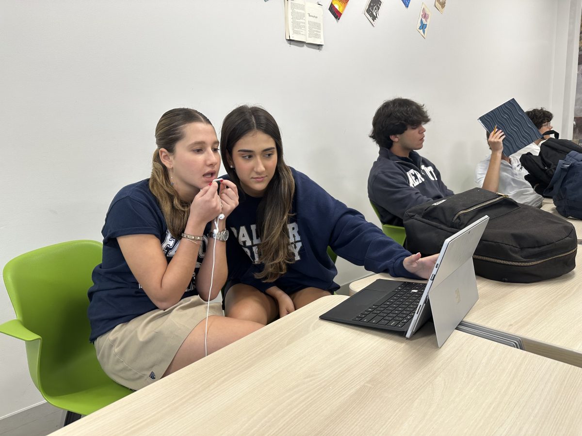 Juniors Paulina Saade and Angelina Fraiz recod their analyses of the film, Blinded by the Light, on Oct. 27 in Eduardo Barretos Honors English class. My favorite part of the project was being able to share my opinions on film along side my friends, Fraiz said.