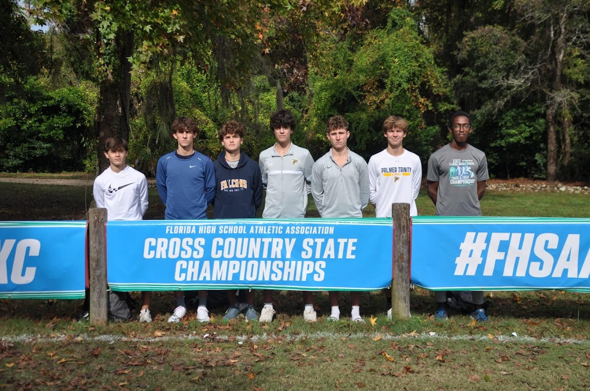 The boys cross country team pose for a picture together at the course the day before the State Championships